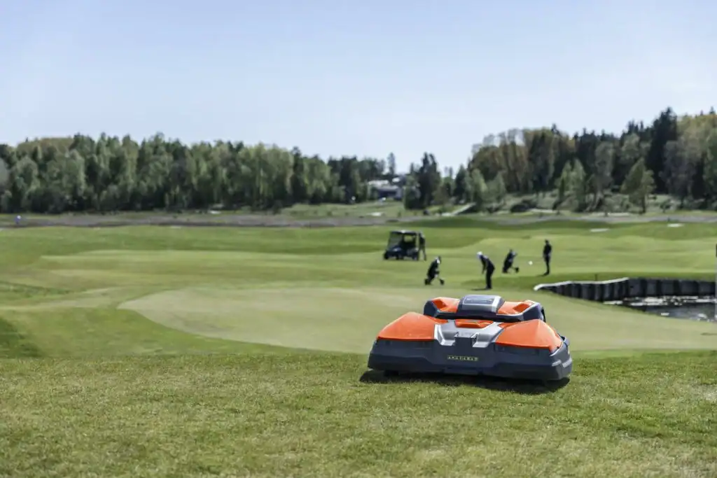 Greenkeeping team working with Husqvarna autonomous mowers on course